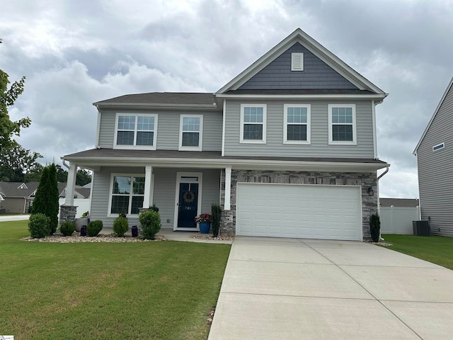 view of front facade with a porch, a garage, central air condition unit, and a front yard