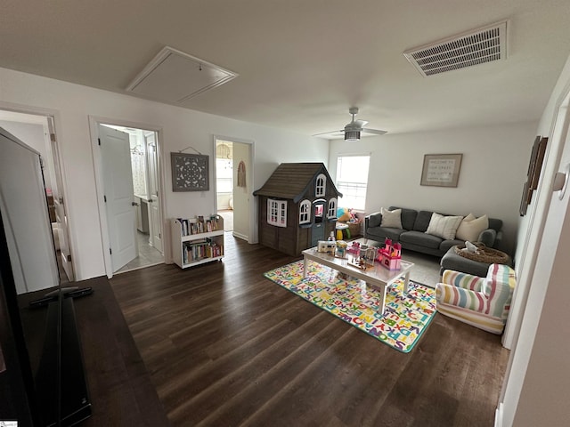 living room featuring ceiling fan and dark wood-type flooring