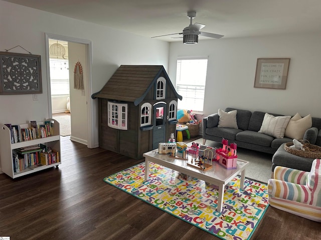 living room featuring ceiling fan and dark hardwood / wood-style floors