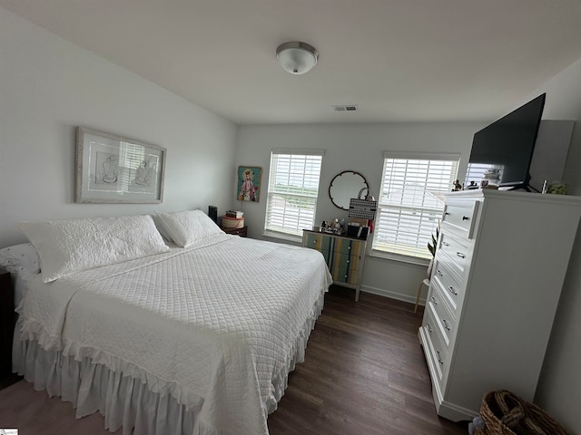 bedroom with dark hardwood / wood-style floors