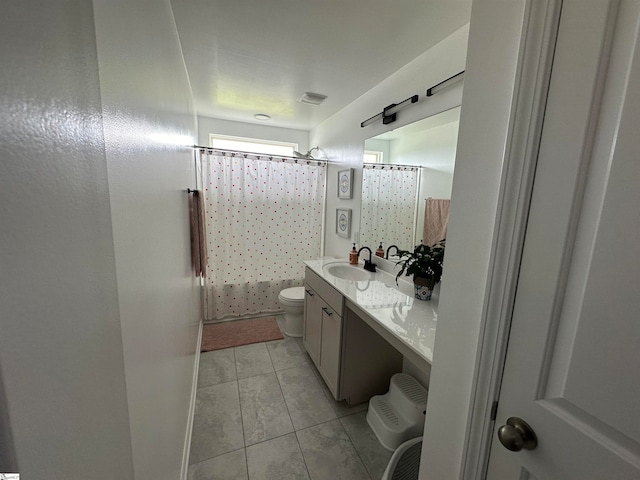 bathroom with curtained shower, vanity, and toilet