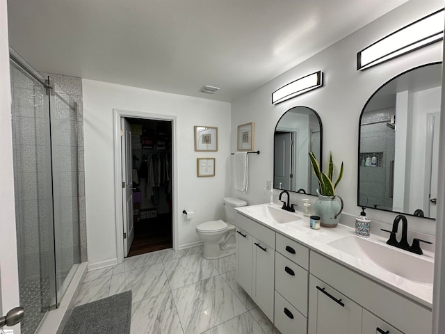 bathroom featuring vanity, toilet, and a shower with shower door