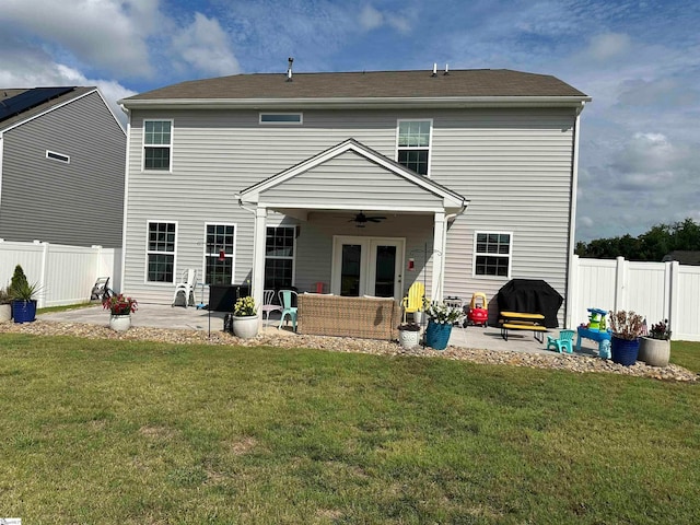 back of property featuring a patio, a lawn, and ceiling fan