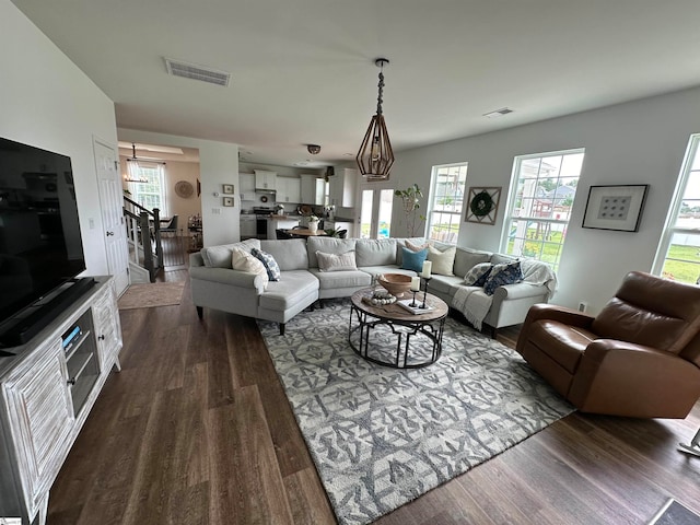 living room featuring dark hardwood / wood-style flooring and a wealth of natural light