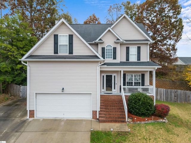 front facade featuring a garage, a front lawn, and a porch