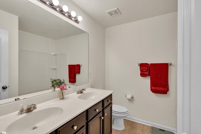 bathroom featuring vanity, toilet, and tile patterned floors