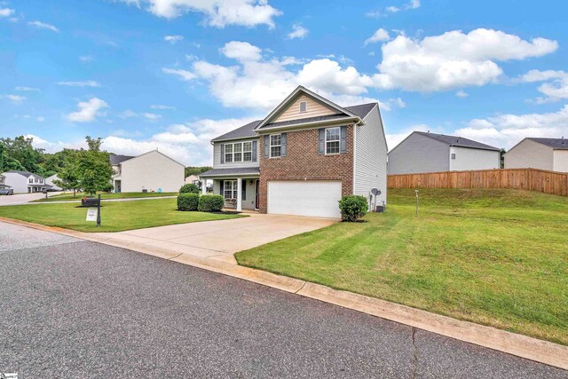 view of front of house with a garage and a front lawn