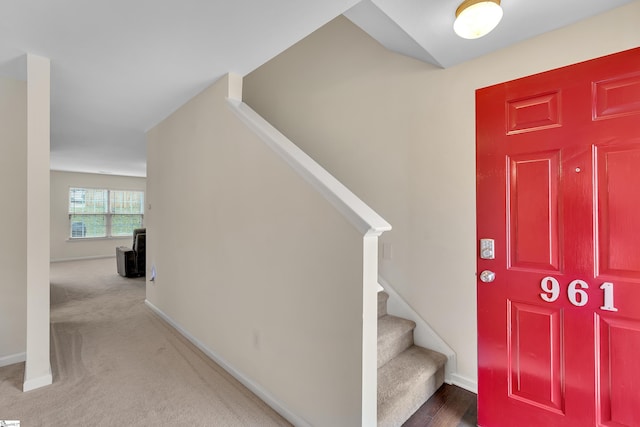 view of carpeted foyer entrance