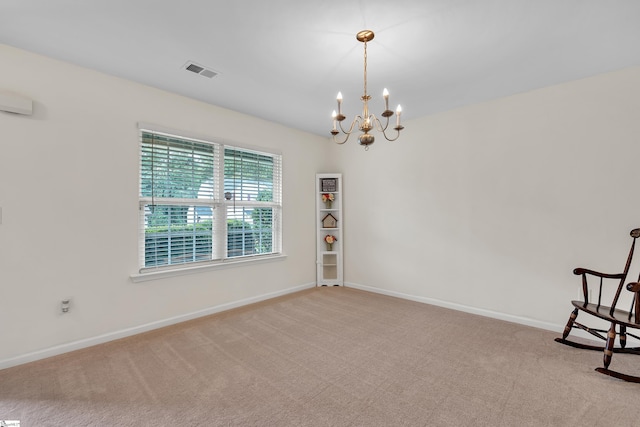 spare room featuring light carpet and a notable chandelier