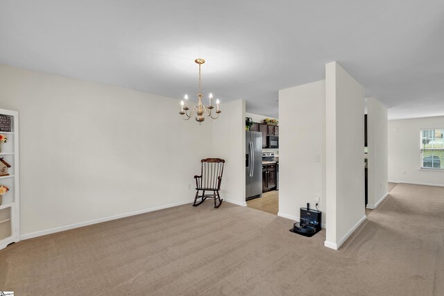 dining space featuring light carpet and a notable chandelier