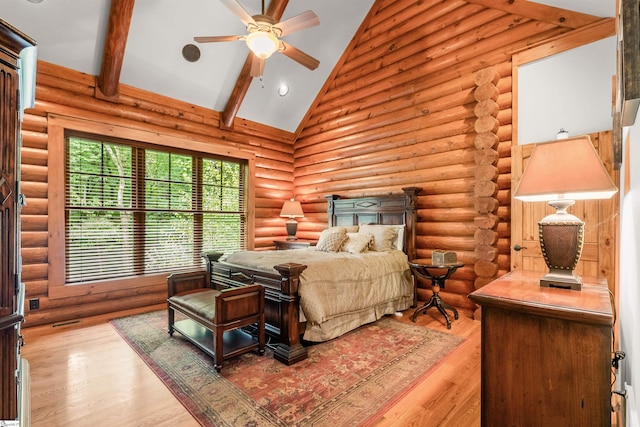 bedroom featuring light wood-type flooring, log walls, beam ceiling, high vaulted ceiling, and ceiling fan