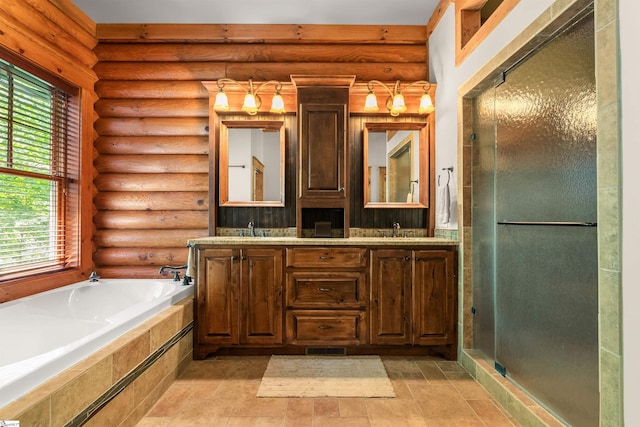 bathroom with log walls, vanity, plus walk in shower, and a wealth of natural light