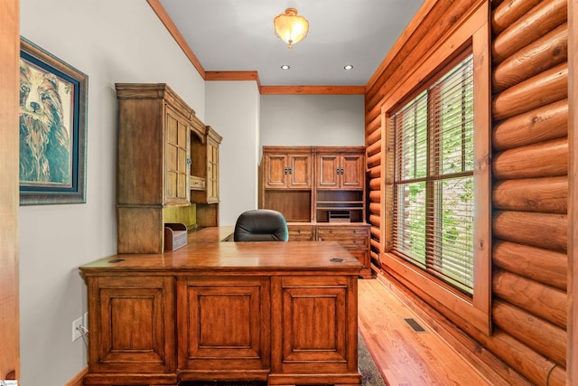 unfurnished office with hardwood / wood-style flooring, crown molding, and log walls