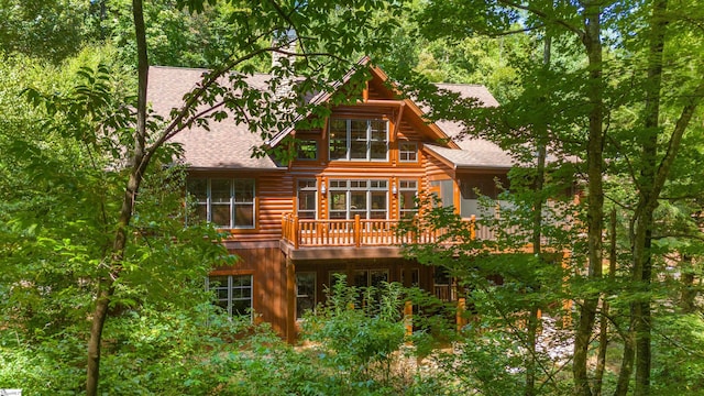 back of property with a wooden deck