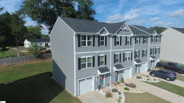 view of front of home with a garage and a front lawn