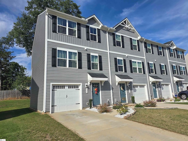 townhome / multi-family property featuring a front yard and a garage