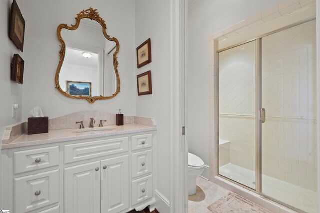 bathroom featuring vanity, an enclosed shower, and toilet