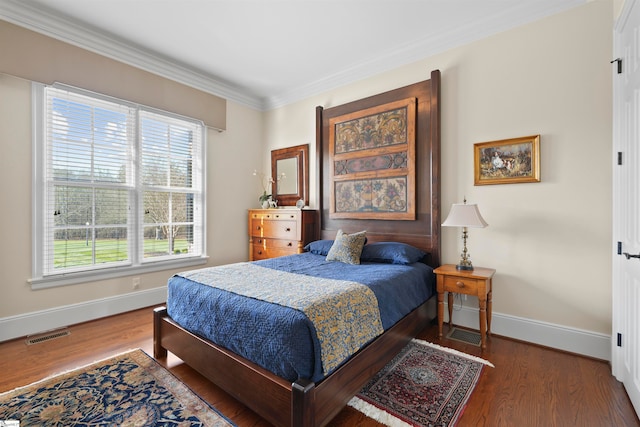 bedroom featuring crown molding and dark hardwood / wood-style floors