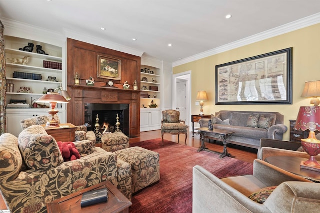 living room featuring wood-type flooring, crown molding, and built in features