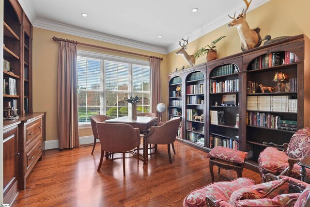 office area featuring wood-type flooring and crown molding