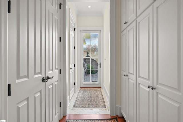 doorway to outside featuring tile patterned floors and crown molding