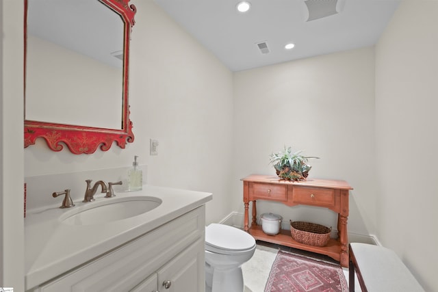 bathroom featuring vanity and toilet