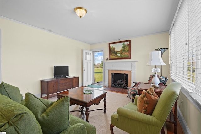 living room featuring crown molding and a tile fireplace