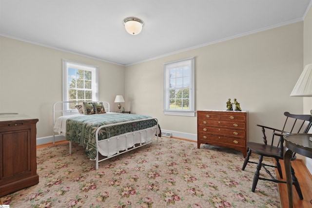 bedroom with ornamental molding and multiple windows