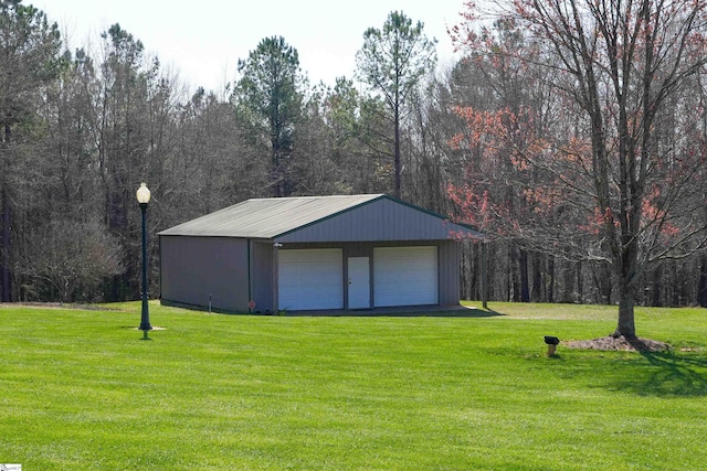 view of outdoor structure with a lawn and a garage