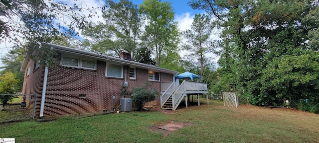 back of house with a wooden deck, a yard, and cooling unit