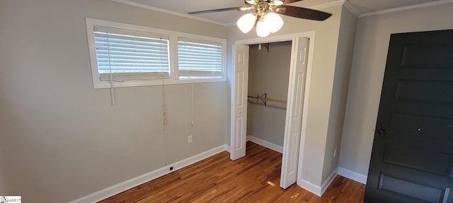 unfurnished bedroom featuring a closet, ceiling fan, crown molding, and hardwood / wood-style floors