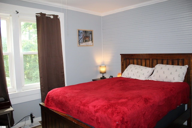 bedroom with multiple windows and crown molding