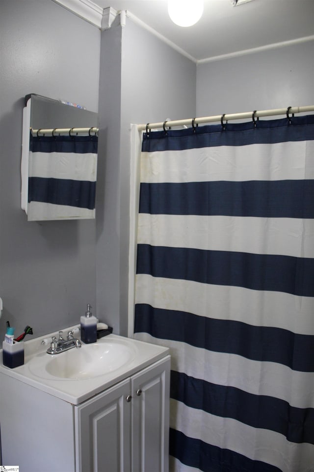 bathroom featuring vanity and ornamental molding