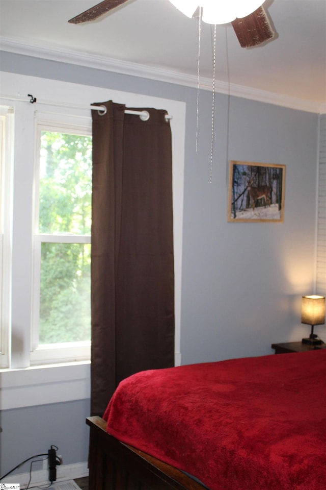 bedroom featuring ceiling fan and crown molding