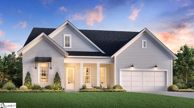 view of front of property with a lawn and a garage