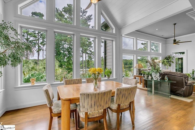 sunroom featuring ceiling fan, plenty of natural light, and vaulted ceiling