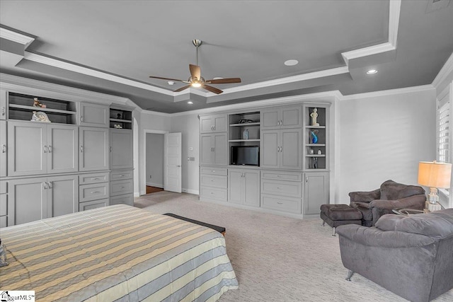 carpeted bedroom featuring ceiling fan, a raised ceiling, and crown molding