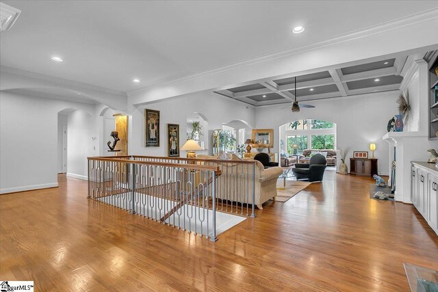 living room with ceiling fan, ornamental molding, beam ceiling, coffered ceiling, and light hardwood / wood-style floors