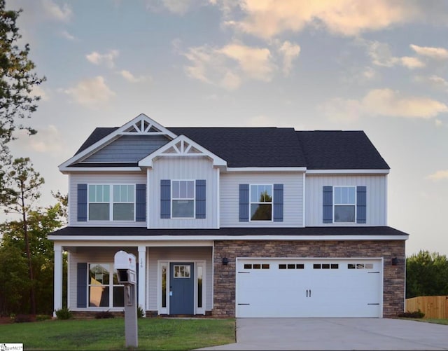 view of front of home featuring a garage, a porch, and a front lawn