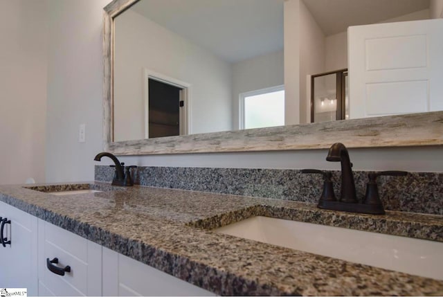 bathroom with an enclosed shower and vanity