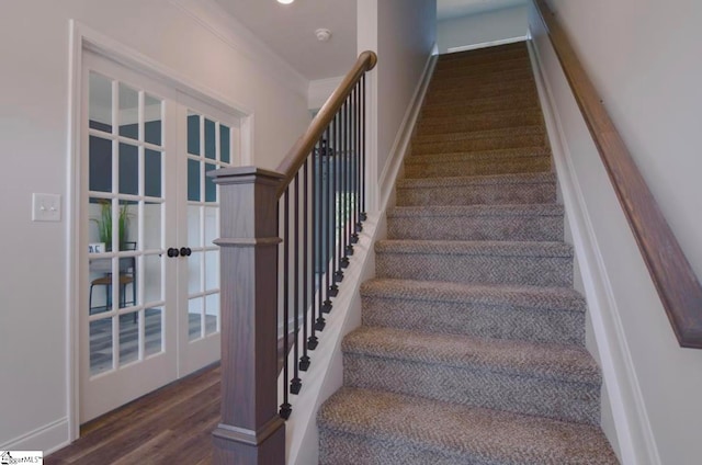 stairs with ornamental molding and wood-type flooring