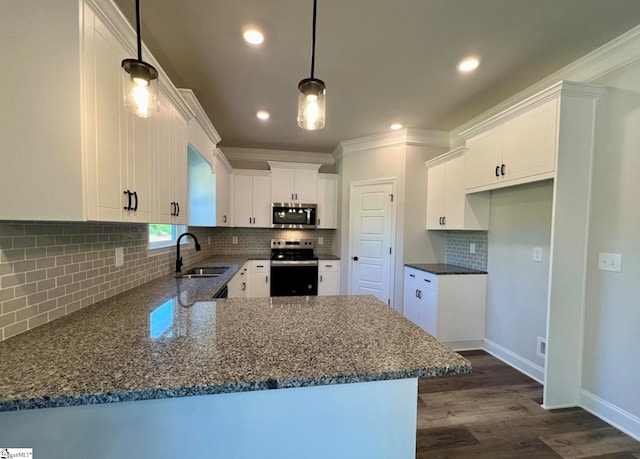 kitchen featuring hanging light fixtures, white cabinetry, kitchen peninsula, stainless steel appliances, and sink