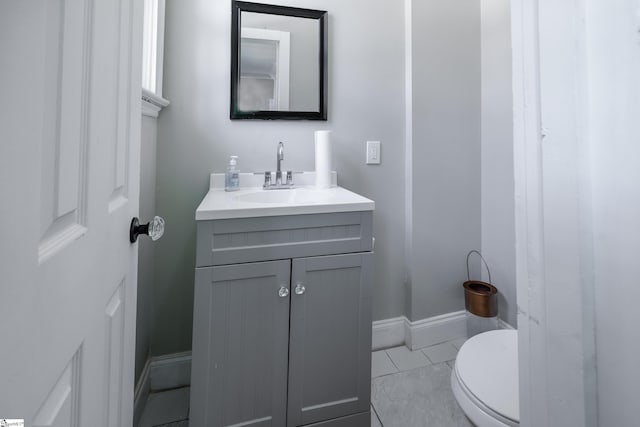 bathroom with vanity, toilet, and tile patterned floors