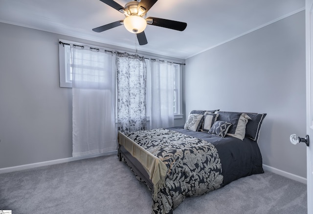 carpeted bedroom featuring ornamental molding and ceiling fan