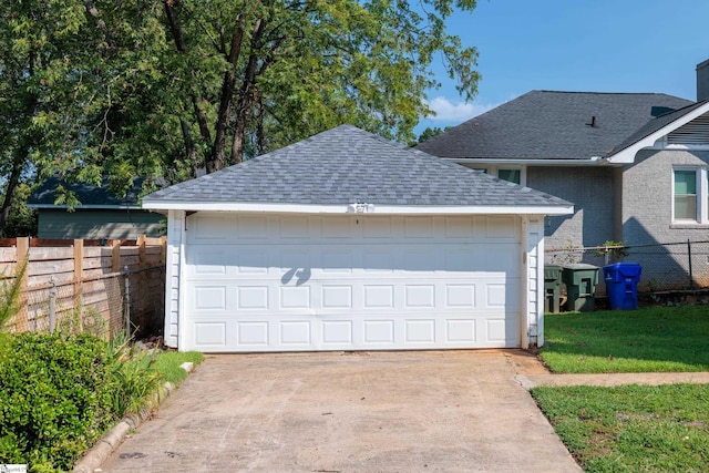 exterior space with a front yard, an outbuilding, and a garage