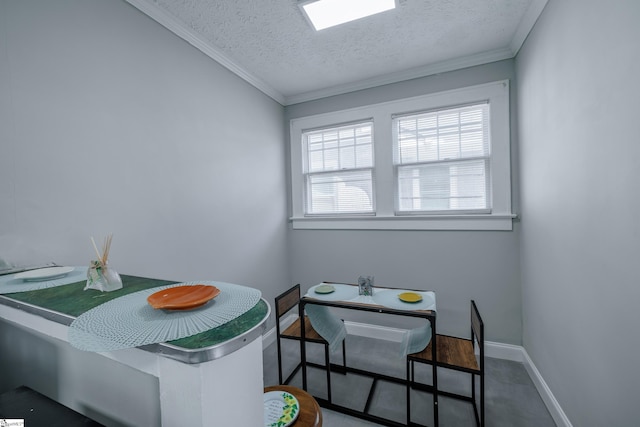 dining area featuring a textured ceiling, crown molding, and a skylight