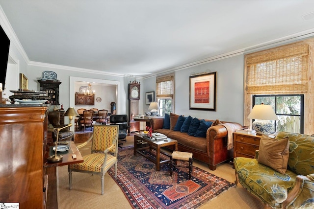 living room featuring a healthy amount of sunlight, carpet flooring, crown molding, and an inviting chandelier