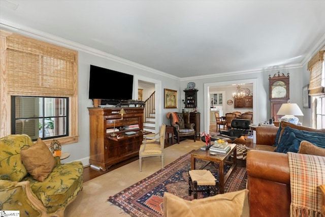 living room featuring hardwood / wood-style flooring, crown molding, a chandelier, and a wealth of natural light