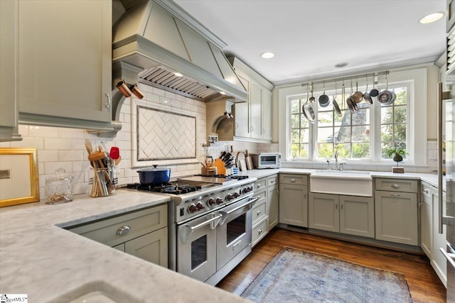 kitchen featuring gray cabinetry, range with two ovens, and sink