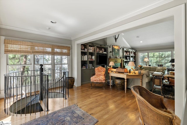 interior space featuring ornamental molding, lofted ceiling with beams, and light hardwood / wood-style floors